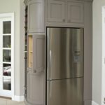 серый холодильник в сером шкафе